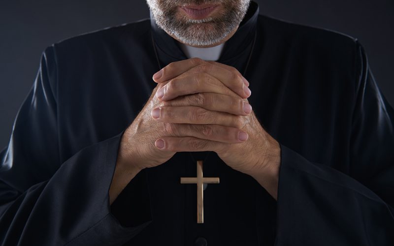 Praying hands priest