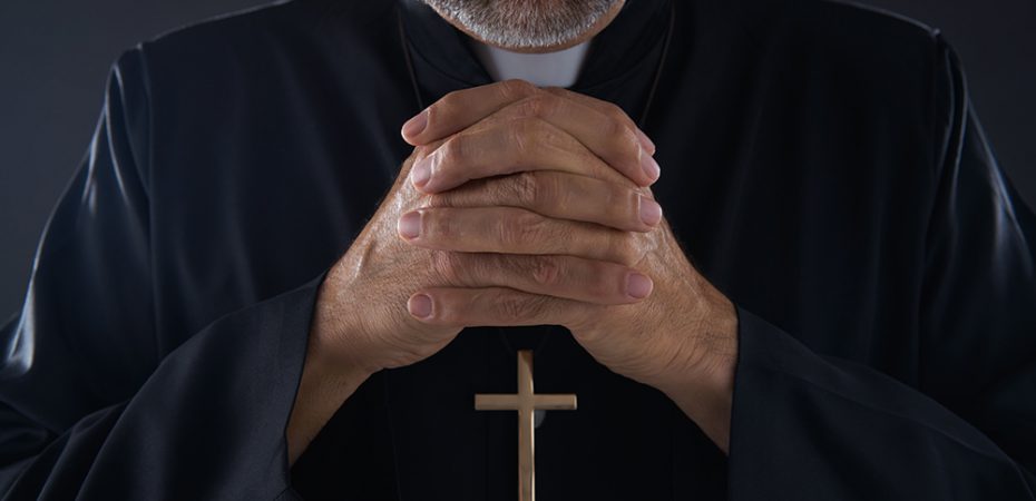 Praying hands priest