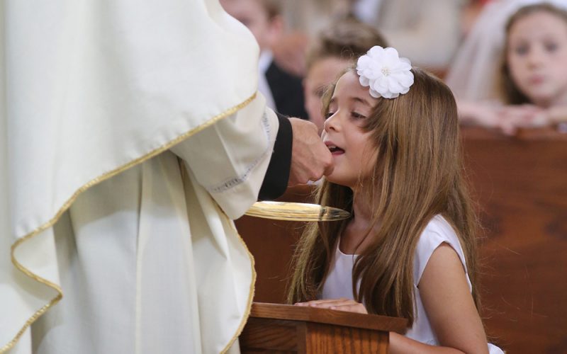 Girl receives first Communion at Maryland church