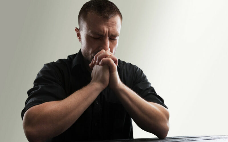 man prays